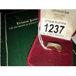 An 18ct gold crossover ring set 7 diamonds, size O. (with original receipt and guarantee).