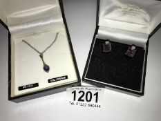 A pair of 9ct gold amethyst set earrings and a 9ct gold amethyst and diamond set pendant.