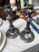 A pair of white metal candlesticks