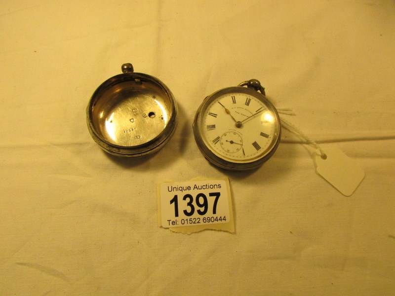 A silver pocket watch and a silver pocket watch case.