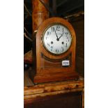 An Edwardian oak mantel clock with silvered dial by Dobson Gradon, Blackhill & Consett.