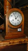 An Edwardian oak mantel clock with silvered dial by Dobson Gradon, Blackhill & Consett.