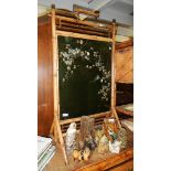 A bamboo firescreen inset with bird decorated glass panel.