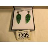 A pair of drop earrings set with jade in the form of leaves and emeralds and diamonds,.