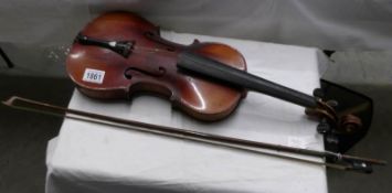 An old violin, stamped Stainer, complete with bow.