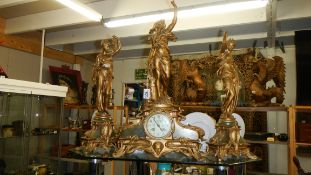 A 3 piece Victorian clock garniture surmounted figures.