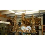 A 3 piece Victorian clock garniture surmounted figures.