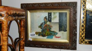 A framed and glazed signed Japanese geisha painting.