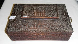 A superb quality oriental carved sewing box complete with interior fittings