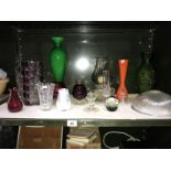 A shelf of art glass including vases & paperweights etc.