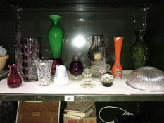 A shelf of art glass including vases & paperweights etc.