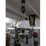 A hanging oil lamp with glass shade.