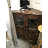 A floor stand glazed wined fold carved corner cabinet