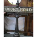 A cast iron street sign 'Court Road' with stanchion.