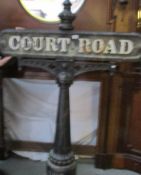 A cast iron street sign 'Court Road' with stanchion.