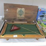 An antique miniature billiard table complete with all balls,