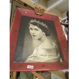 A framed portrait photograph of Queen Elizabeth II.