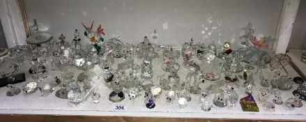 A shelf of small glass ornaments mostly dogs,