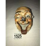 A novelty ashtray as a clowns head.