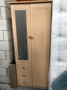 A mirrored wardrobe with 3 drawers