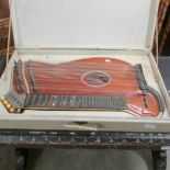 A cased 36 string zither by Han Haubner, Mariembad, Germany.
