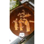 An oval Japanese wall plaque with 3 figures.