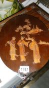 An oval Japanese wall plaque with 3 figures.