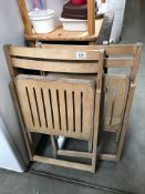 A pair of wooden folding chairs