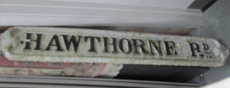 A cast iron street sign 'Hawthorne Road'.