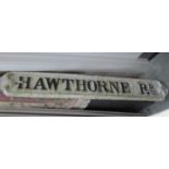 A cast iron street sign 'Hawthorne Road'.