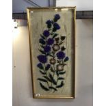 A framed & glazed wool embroidery of flowers