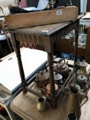 An oak carved side table with spindle legs