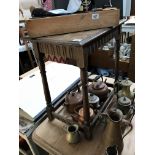 An oak carved side table with spindle legs