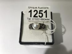 A silver and pearl ring, size P.