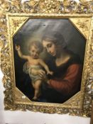 A large gilt framed oil on canvas painting of Madonna and child.