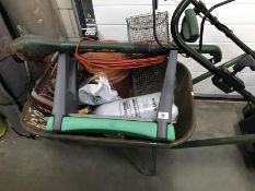 A wheelbarrow & contents (gas stove, gardening stool, rodent trap & strimmer etc.