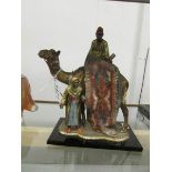 A painted white metal figure of a carpet seller, made in Austria.