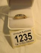 A 14k gold and diamond eternity ring, size O. (with certificate).