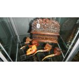 An ornately carved wood pipe rack with 5 pipes including horse heads.