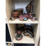 2 shelves of colourfully painted wooden ornaments