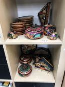 2 shelves of colourfully painted wooden ornaments