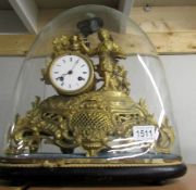 A gilded clock under dome (feather damaged).