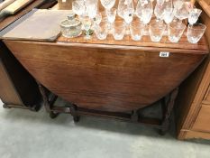 An oval drop leaf table