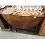 An oval drop leaf table