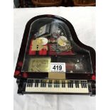 A Grand piano shaped musical jewellery box with some jewellery & a ladies watch