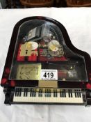 A Grand piano shaped musical jewellery box with some jewellery & a ladies watch