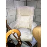 A cream coloured cloth upholstered executives chair