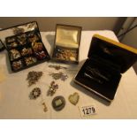 A mixed lot of earrings, brooches, pendants etc.