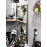 A bevel edged long rectangular mirror with gilt frame