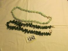 2 jade necklaces,.